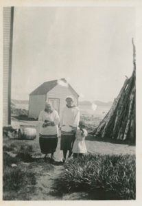 Image of Mrs. Paul Hettasch, Miriam MacMillan and Eskimo girl walking down village